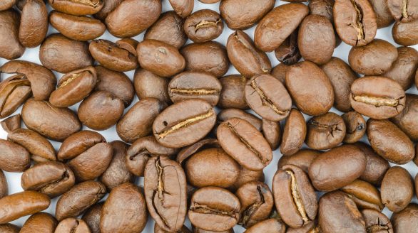 A detailed close-up of fresh roasted coffee beans showcasing their rich texture and color.